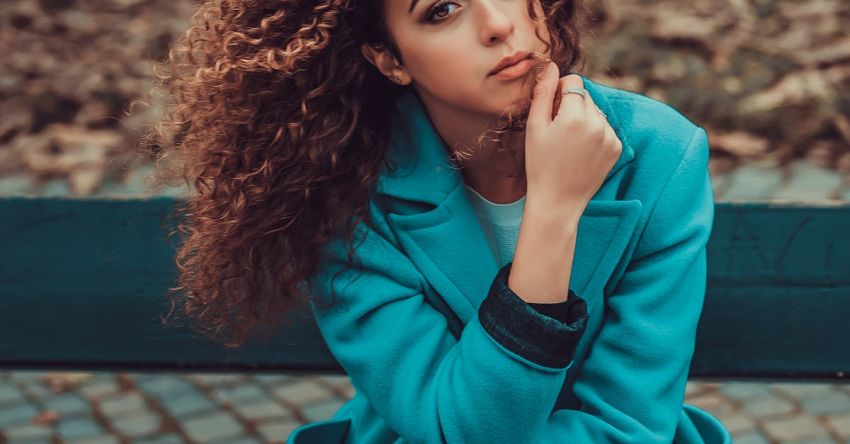 Curly Hair - Photo of Woman Sitting on Park Bench