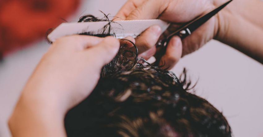 Hair Trims - From above of crop anonymous master cutting hair of male client in modern barbershop