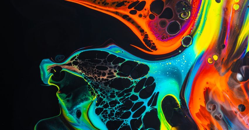 Vibrant Colors - Colorful mix of neon paints swirling on black surface