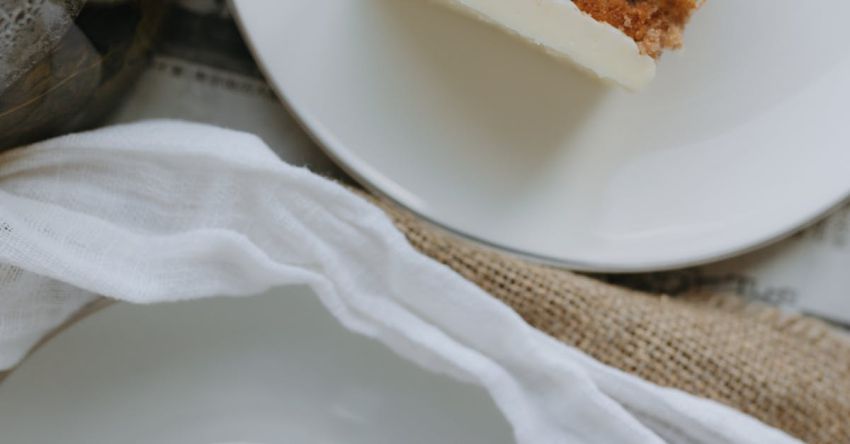 Layered Haircuts - A white plate with a piece of cake and a cup of tea