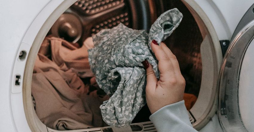 Everyday Wear - Crop unrecognizable female loading dirty clothes in modern white washing machine while doing housework routine in light room at home