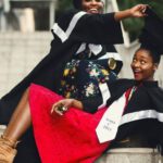 Removing Extensions - Shallow Focus Photography of Two Women in Academic Dress on Flight of Stairs