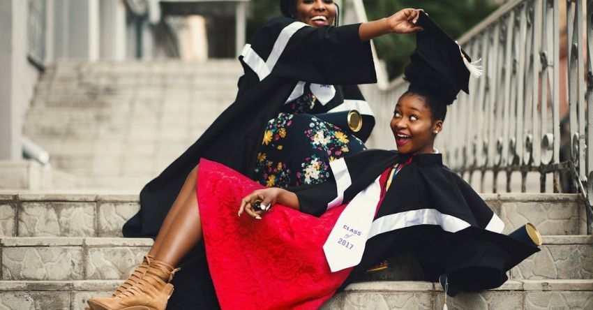 Removing Extensions - Shallow Focus Photography of Two Women in Academic Dress on Flight of Stairs